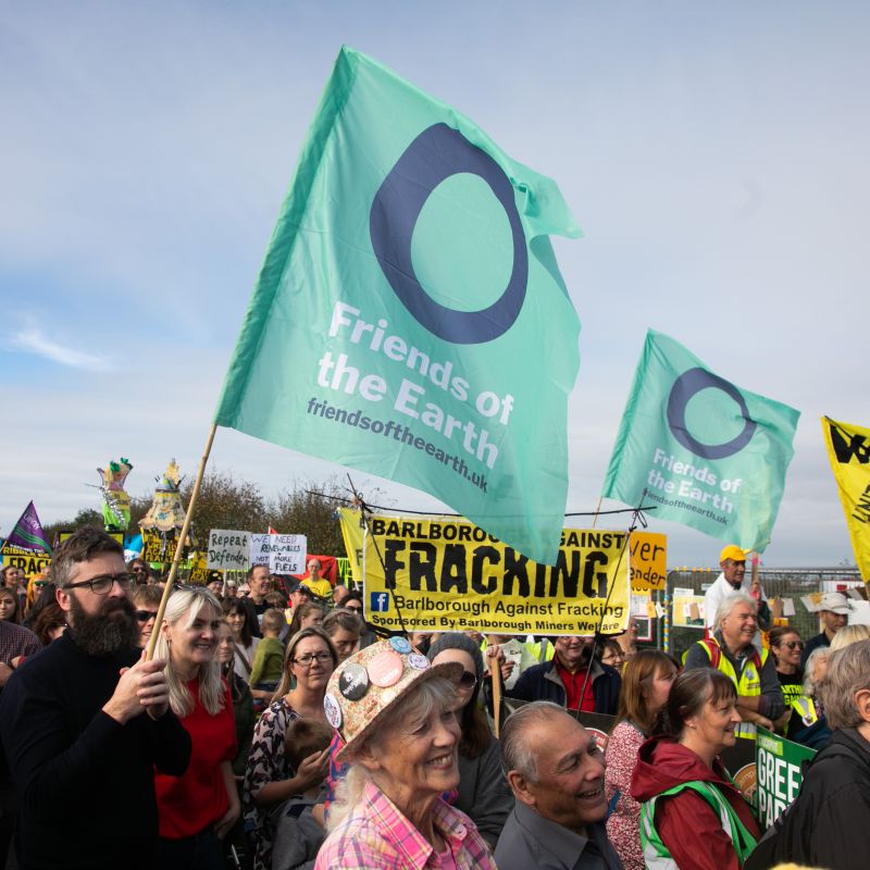 A rally against fracking at Preston New Road, Lancashire. People can be seen holding anti-fracking and Friends of the Earth banners.