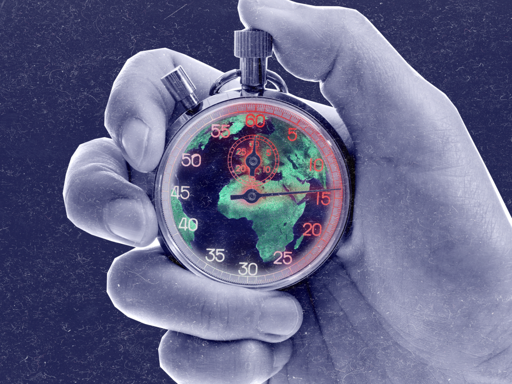 Hand holding a ticking clock