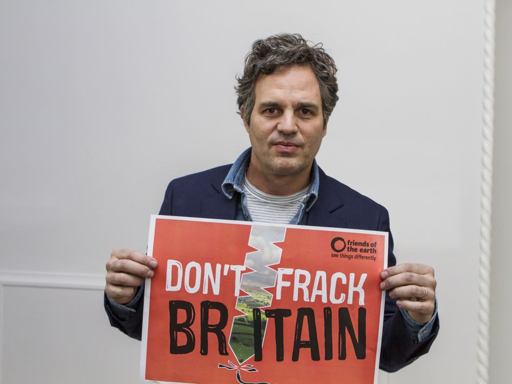Actor Mark Ruffalo holding a sign that reads "Don't frack Britain"