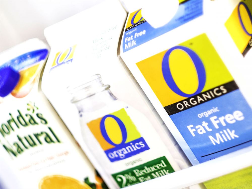 Organic milk and orange juice drink cartons in refrigerator