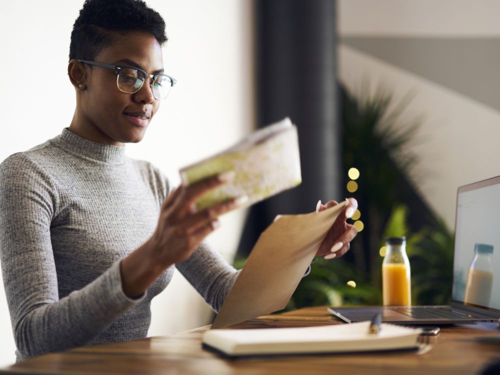 Woman putting something in an envelope